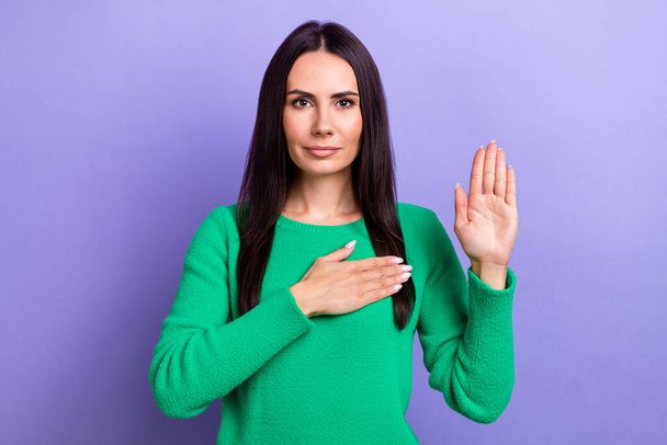 Photo of pretty shiny lady dressed green sweater rising arms chest swearing tell only truth isolated violet color background. - Fotografie, Obrázek