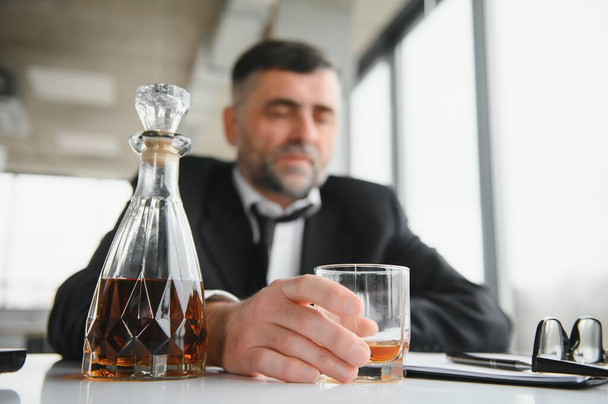 Old businessman drinking from stress - Foto, Imagem