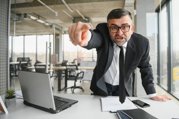 Angry businessman with too much work in office. - Photo, image