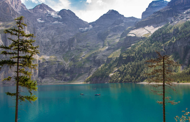 Oeschinen Lake (Oeschinensee) in Kandersteg, the Bernese Oberland, Switzerland, part of the UNESCO World Heritage Site - Фото, изображение