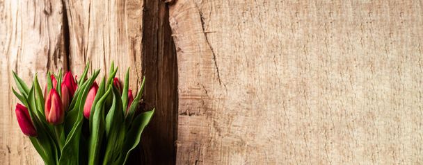 Bouquet of tulips on wooden background. Gift, concept of spring. Mother's Day Greetings. Banner. Place for text - Fotoğraf, Görsel
