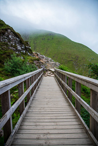 Landscape photography of mountains and wooden bridge, stones, path - Zdjęcie, obraz