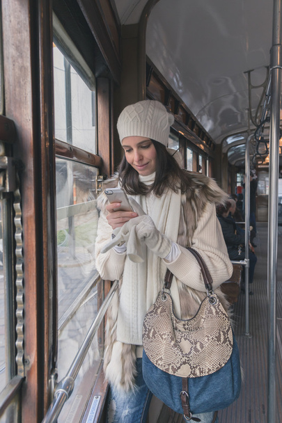 Beautiful young woman posing on a tram - Foto, imagen