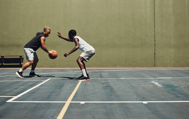 Exercise, sports and basketball friends training at basketball court for health, cardio and speed challenge. Fitness, energy and men practice skill together, having fun and enjoying workout with ball. - Foto, Imagen