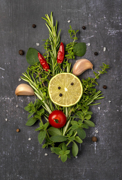 Food photography of herbs, Garlic, rosemary, thyme, oregano, chili, lime - Фото, изображение