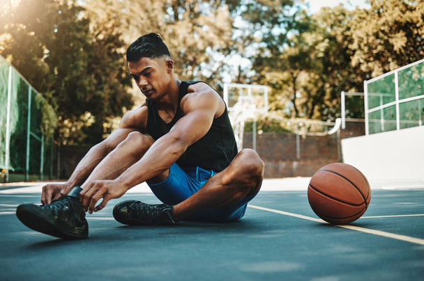 Basketball court, man and shoes prepare for training at recreation and athlete facility. Sports, exercise and fitness male with lace tie getting ready for ball game workout and cardio - Photo, Image