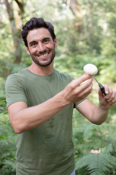 man found a mushroom in the forest - Photo, image