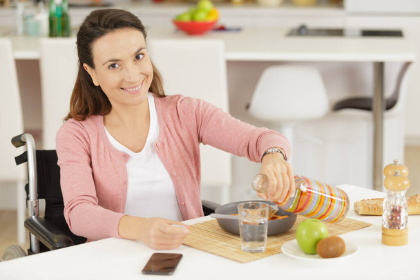 disabled woman eating meal at home - Foto, Imagem