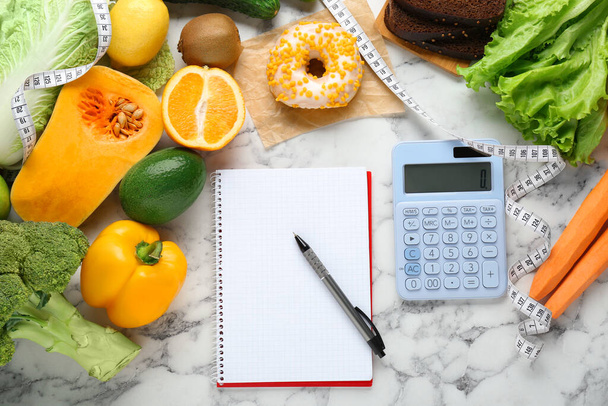 Food products, notebook with calculator on white marble table, flat lay. Weight loss and calorie counting concept - Foto, Bild