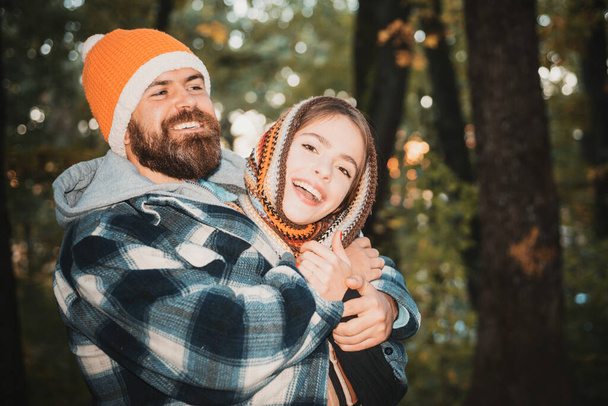 Bearded man and pretty woman on autumn background for Copy space. Love, relationship, family and people concept - close-up of smiling couple in autumn park. Portrait of young beautiful couple in park - Фото, изображение