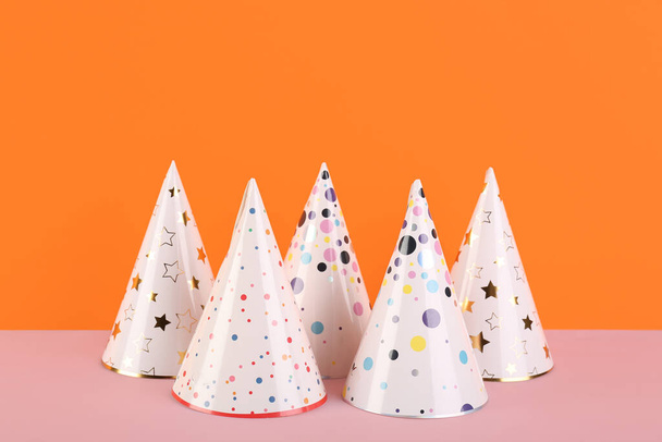 Different party hats on color background - Foto, immagini