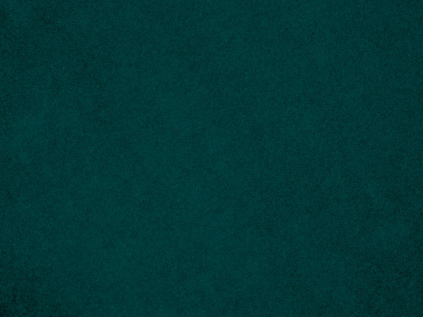 Dunkelgrüne Samttextur, die als Hintergrund dient. Leerer grüner Stoffhintergrund aus weichem und glattem Textilmaterial. Es gibt Raum für Text. - Foto, Bild