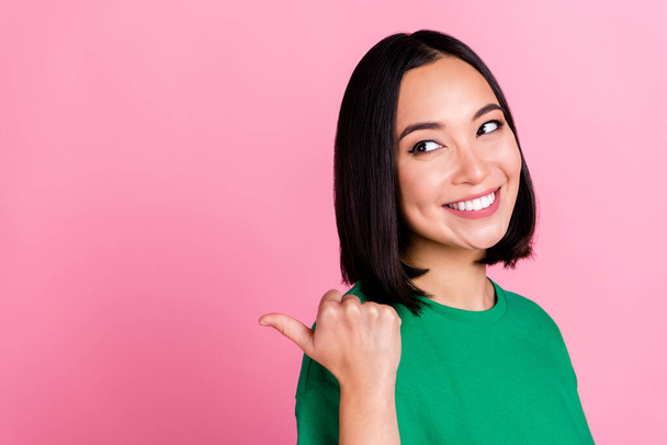 Profile photo of cute cheerful lady look indicate finger empty space isolated on pink color background. - Фото, зображення