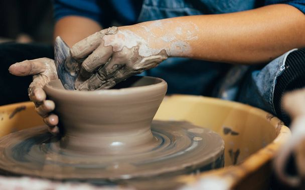 Professional craftsman potter making jug of clay on the potters wheel circle in workshop, Traditional handicraft working, Creativity and art of pottery - Foto, Imagen
