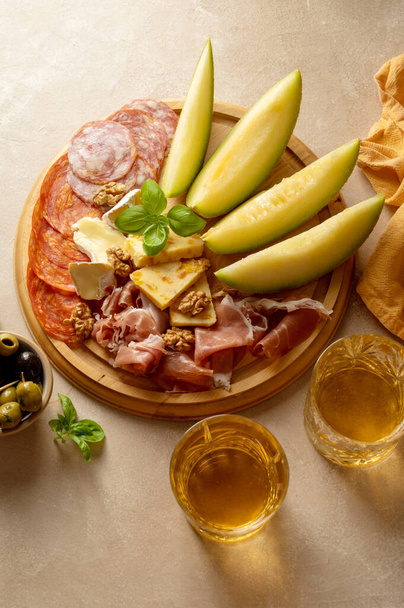 Charcuterie gourmet antipasti plater cheese, salami, prosciutto, melon board. Top view. - Fotografie, Obrázek