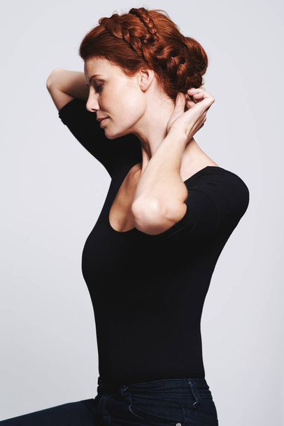 No more bad hair days with braids. Studio shot of a beautiful redhead woman with a braided up-do posing against a gray background - Foto, afbeelding