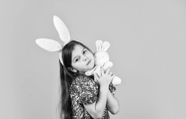 Happy childhood. Cute child play with toy. Toys shop. Girl in adorable funny rabbit ears. Happy easter holiday. Spring holiday preparation. Tender love. Springtime concept. Little girl hold hare toy. - Foto, Imagen