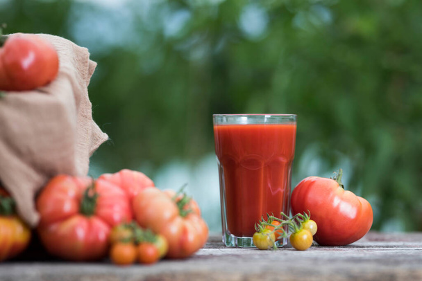 Fresh tomato juice, on a wooden background - Photo, Image