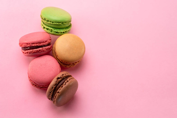 Colorful french macarons isolated on pink background. Top view. - Photo, Image