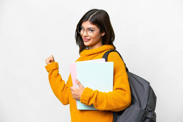 Jovem estudante mulher sobre isolado fundo branco apontando para trás - Foto, Imagem