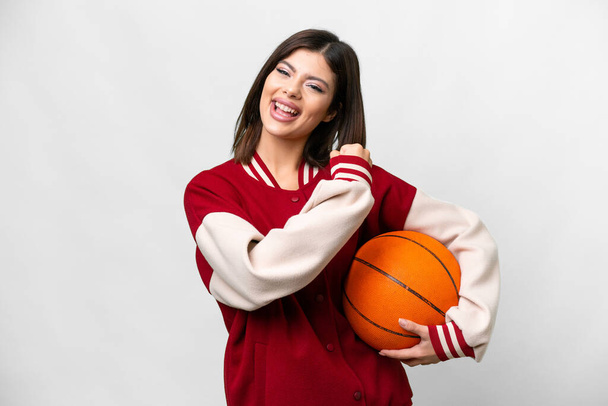 Young Russian woman playing basketball over isolated white background celebrating a victory - Fotoğraf, Görsel