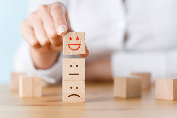 Customer hand choose smiley face on wood cube, Service rating, satisfaction concept - Photo, Image