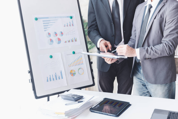 Finance and investment concept, Businessman present business finance investment plan with his partner, Investor colleagues discussing new investment plan by financial graph data on office table - Foto, imagen