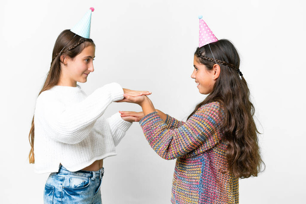 Amigos niñas en una fiesta de cumpleaños sobre fondo blanco aislado - Foto, imagen