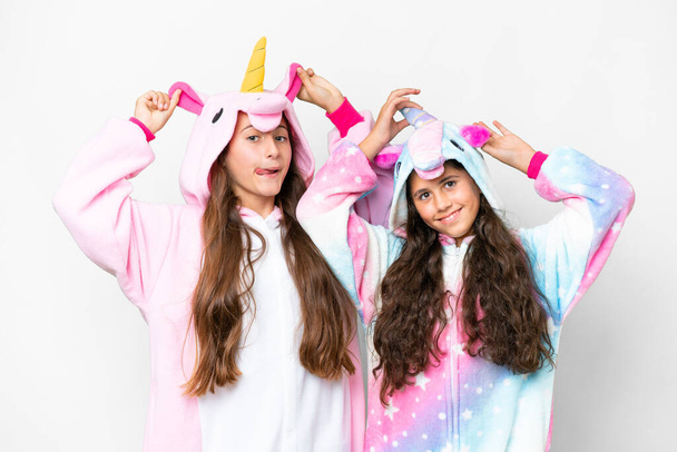 Friends girls with unicorn pajamas over isolated white background - Fotoğraf, Görsel