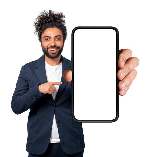 Happy arab businessman pointing at smartphone with mockup blank screen, smiling portrait looking at the camera. Isolated over white background. Concept of online shopping - Foto, Imagen
