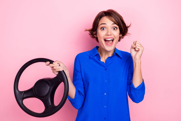 Photo of young funny business manager corporate celebrate lottery winner get new automobile steering wheel fist up isolated on pink color background. - Фото, зображення