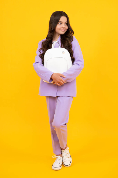 Fashion schoolgirl with backpack. Teenager student, isolated background. Learning and knowledge. Go study. Children education concept. Back to school. Happy face, positive and smiling - 写真・画像