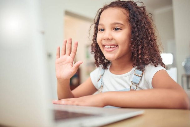 Elearning, video call and child with laptop in online class wave hello for learning, education and knowledge. Young girl kid or child taking a digital home e learning course with internet zoom call. - Foto, Imagen