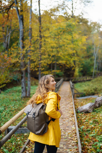 Portrait of young woman walking in  the forest. Travelling, lifestyle, adventure. - Foto, Imagen