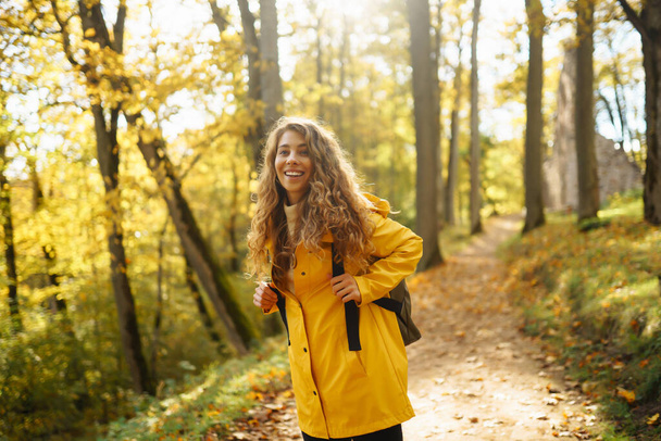 Portrait of young woman walking in  the forest. Travelling, lifestyle, adventure. - Foto, Imagem