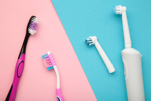 Electric and manual toothbrush on colorful background. Top view - Φωτογραφία, εικόνα