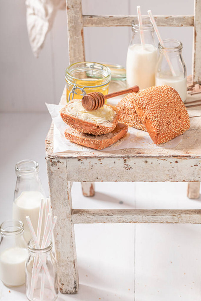 Homemade buns with honey for breakfast in farm. Breakfast with milk and honey. - Φωτογραφία, εικόνα