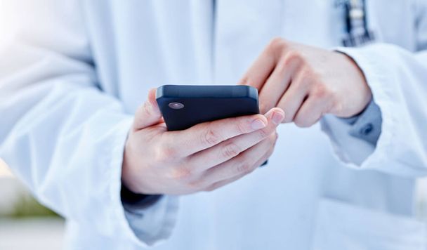 Closeup, hands and doctor with smartphone, online reading or connection for typing. Zoom, medical professional or cellphone for social media, research or search internet for information or healthcare. - Foto, Bild