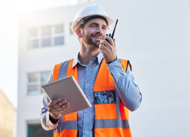 Engineering, construction worker or man for project management, planning and communication on tablet and walkie talkie. Architecture, contractor or builder person with 5g technology at industrial job. - Foto, Bild