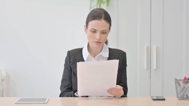 Young Businesswoman Reading Documents in Office, Paperwork - Foto, afbeelding