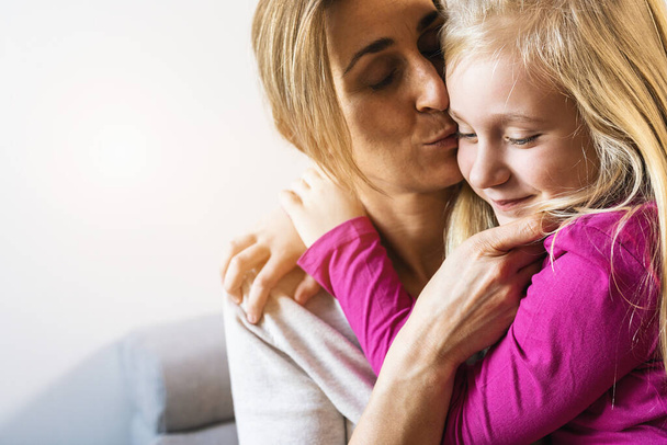 Mother and her daughter child girl kissing and hugging. Happy loving family concept image - Photo, Image