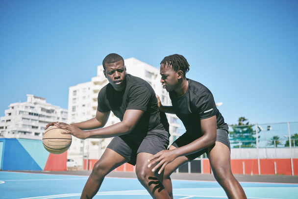 Basketball, fitness and active sports game played by young African men in an outdoor court for exercise. Training, workout and healthy guy friends playing a fun, friendly and athletic sport in summer. - Foto, Bild