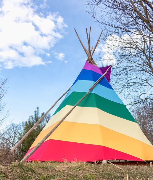rainbow-coloured tepee set up in the garden, early spring, traditional Indian dwellin - Photo, Image