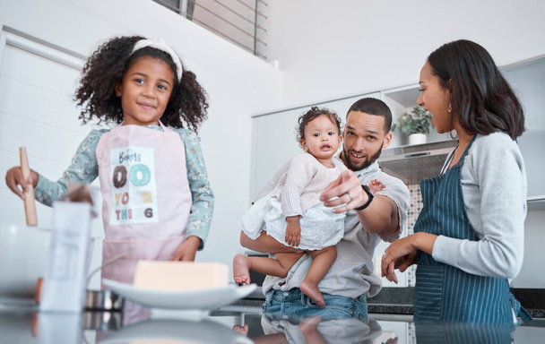 Kitchen cooking, pointing and family of happy parents, baby and children learning to bake food, bonding and having fun. Black family love, child development and mother and father teaching kids baking. - Photo, Image