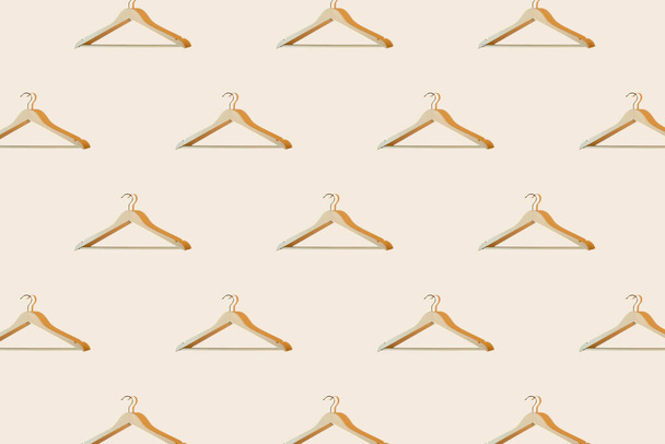 Coat hangers on pastel background with shadows. Seamless pattern, sale banner concept - Photo, Image