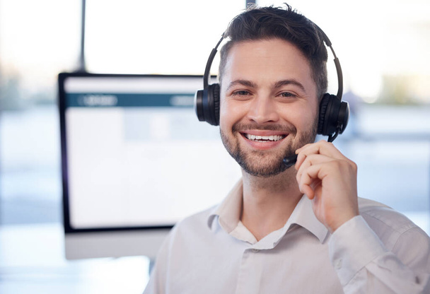 Man at call center, face and contact us with customer service employee, smile and CRM with consultant. Professional, portrait and communication, male with headset with help desk and telemarketing. - Photo, image
