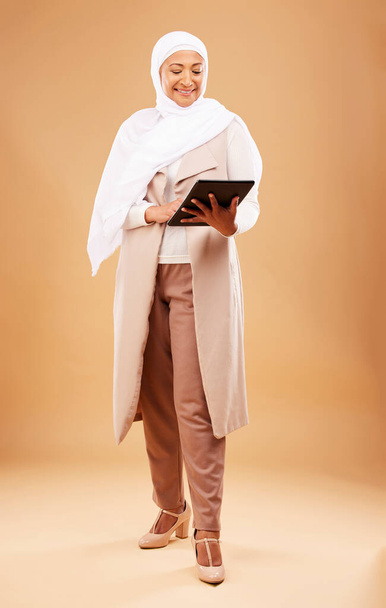 Happy muslim woman, tablet and technology on studio background for website, social network and internet app on studio background. Mature lady in islamic hijab search digital connection in Malaysia. - Zdjęcie, obraz
