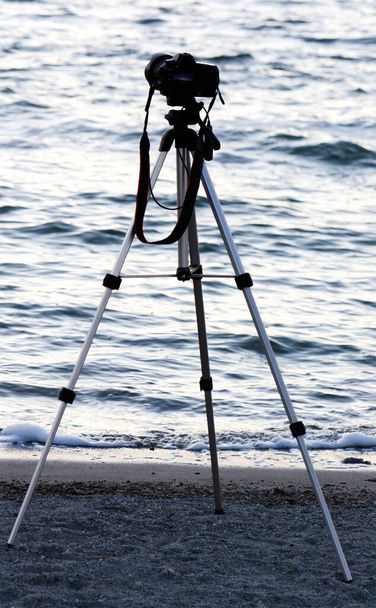 Camera Mounted On Tripod On Shore Of Water Poted Out at Waves - Фото, зображення