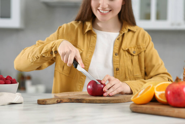 Woman preparing ingredients for tasty smoothie at white marble table in kitchen, closeup - 写真・画像