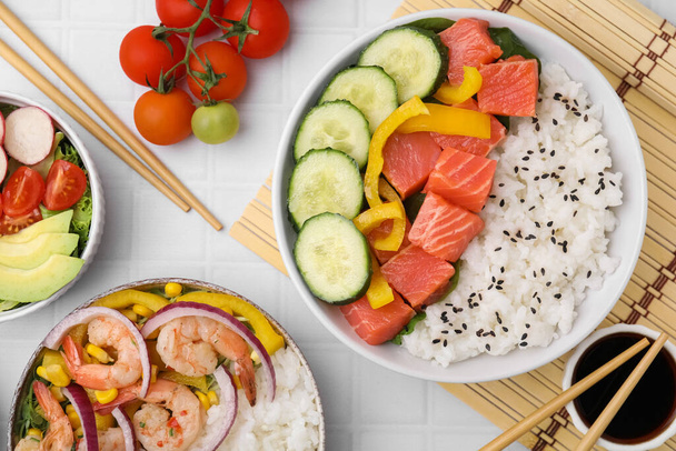 Set of delicious poke bowls with different ingredients on white table, flat lay - Photo, Image